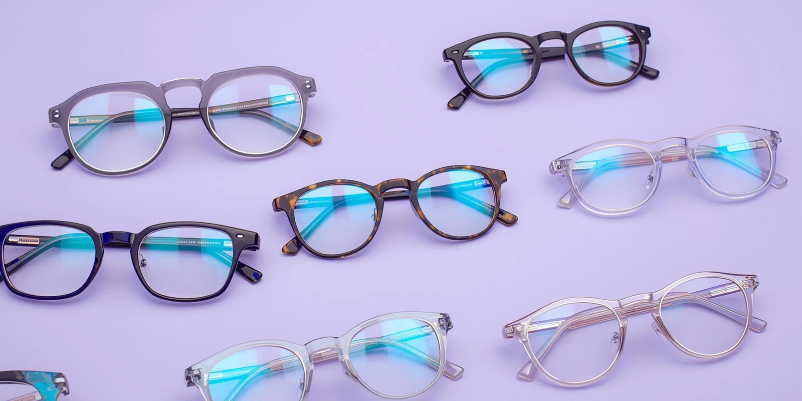 Collection of various eyeglasses on a light purple background